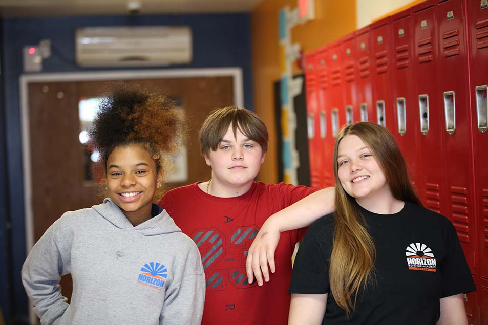 student in classroom smiling at camera